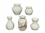 PORCELANAS, lote com cinco (5) vasos confeccionados em porcelana na tonalidade branca de modelos, tamanhos e decorações distintas, maior medindo 8,5x4cm e menor 5,5x4cm.