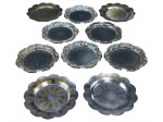 METAL PRATEADO, dez (10) porta copos confeccionados em metal espessurado a prata de dois modelos com cinzelado de elementos vegetalistas, 3 apresentam falhas na prateação, maior medindo 11cm e 10cm.