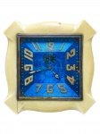 RELÓGIO, um (1) relógio despertador, sem manufatura aparente, mostrador quadrado em tonalidade azul (sinais de rachaduras), numerais arábicos em relevo, caixa em material similar ao marfim e estrutura traseira em metal dourado, apresenta rachadura na estrutura, marcas do tempo, não testado e sem garantia de funcionamento, medindo 10x10cm.