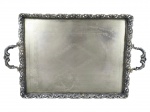 METAL PRATEADO, uma (1) bandeja retangular, confeccionado em metal espessurado a prata, fundo cinzelado por elementos vegetalistas, galeria por cachos de uva e folhas de parreira em vazados, apoiado sobre 4 pés finalizados em garra, medindo 52,5x33cm, falhas na prateação.