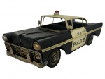 COLECIONISMO, uma (1) miniatura representando viatura policial, em lata, nas cores preta e branca, com sirene superior vermelha, portas com inscrição POLICE e numeração, apresentando sinais do tempo, desgastes, sujidades, oxidações e marcas de uso. Peça no estado, medindo 10x28x11cm.