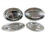 METAL PRATEADO - Lote com (4) travessas confeccionadas em metal espessurado à prata sendo (3) da manufatura Wolff , duas ovaladas e uma redonda com frisos cinzelados em gomos e folhagens , medidas : 29 / 37 x 25 e 42 x 30 cm  e (1) da manufatura Christofle , borda e corpo liso , possui diversas ranhuras , medida : 44 x 28 cm