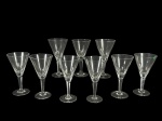 CRISTAIS, nove (9) taças para vinho, confeccionadas em cristal translúcido, bojo cônico com lapidação dita DEDÃO, haste facetada, apoada sobre base circular, 8 apresentam pequenos bicados na borda, medindo 16x8cm.