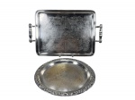 METAL PRATEADO, lote com duas (2) bandejas confeccionadas em metal espessurado a prata, sendo: A) 1 retangular, da manufatura BEL PRATA, cinzelada por elementos vegetalistas, alças torneadas em perolados, medindo 49x32,5cm e B) 1 redonda, cinzelada por elementos vegetalistas, bordas em concheados e folhagens, apresenta falhas na prateação, medindo 31cm de diâmetro.