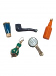 JOIA DE CRIOULA, cinco (5) pingentes em formatos diversos, sendo: A) um (1) em formato atabaque em material azul, com armação em ouro, medindo 2cm,; B) um (1) em formato de cachimbo, em material escuro, com armação em prata de lei, medindo 3cm, C) um (1) em formato de garrafa, em material alaranjado, com armação em ouro, medindo 3cm; D) um (1) em formato bojudo, em material verde, com armação em ouro, medindo 2,5cm e E) um (1) em formato de instrumento musical, com armação em ouro e aplicação circular em madrepérola. medindo 2,5cm, peso total bruto 5,8g. OBS: SÃO DE OURO DE BAIXO TEOR.