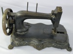 Antiga máquina de costura vintage aparentemente da marca Esco Punda, com estrutura de ferro fundido e acabamento detalhado, med. aproximadamente 40cm