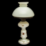 Séc. XIX - Antigo lampião em vidro opalinado branca com montagem em bronze patinado. Base ornamentada em policromia com decoração floral e filetes dourados, construída com pé circular, encimado por colunata afunilada reta e reservatório bojudo. Cúpula semiesférica, rematada por pequeno gargalo anelado. . 37 x 20 cm.