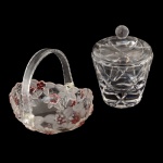 Conjunto de 2 peças em vidro, sendo: A) Centro de mesa na forma de cestinha com decoração floral na cor rosa (8 x 18 x 14 cm). B) Biscoiteira circular com pega na tampa na forma de bolota (16 x 13 cm)