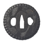 Final do Período Momoyama (1573-1603) / Início do Período Edo (1603-1867) - Antiga e original tsuba em ferro carbono forjado, de formato marugata, praticamente circular, lavrada no formato de roda de carro de boi. Apresenta delicados veios da madeira finamente esculpidos, ornamentados por reservas com delicados zogan, adornos geométricos, embutidos em prata e ouro. O mimi, a borda externa, reforçada por faixa martelada com gomos alinhados. Final do Período Momoyama (1573-1603) / Início do Período Edo (1603-1867). 7.5 x 7 cm
