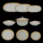 Serviço para jantar em porcelana nacional da manufatura Real. Fundo de superficie branca com friso dourado. Marca da manufatura no verso. Constando de 42 peças, sendo: 1 sopeira circular (11 x 24 x 20 cm), 2 saladeiras ovais (6 x 25 cm / 5 x 22 cm), 3 travessas ovais (37 x 24 cm / 32 x 21 cm / 28 x 20 cm), 12 pratos rasos (24 cm / 2 com bicados), 12 pratos fundos (23 cm) e 12 pratos para sobremesa (19 cm).