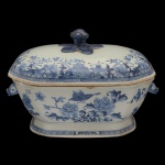 CHINA. Dinastia Qing. Séc. XVIII / XIX - Sopeira em porcelana chinesa da Companhia das Índias. Apresenta formato retangular com decoração em azul underglaze sobre branco com flores e folhagens. Pega da tampa na forma de flor e pegas laterais na forma de cabeça de lebre. China. Dinastia Qing (1644-1911). Apresenta restauro na pega e nas alças. 30 x 21 cm.