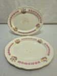 Jogo de 2 travessas ovais rasas em faiança Inglesa, floral com friso ouro. Medindo 31cm x 25cm; 27,5cm x 21,5cm.