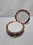 Jogo de 6 pratos de sobremesa em porcelana Renner Donaire vinho com friso ouro. Medindo 17,5cm de diâmetro. Desgaste no friso.