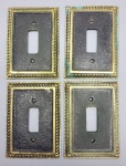 BRONZE - Lote de 4 espelhos para interruptor. Med. 12x9 cm. Marcas de uso.