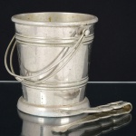 METAL PRATEADO, um (1) balde de gelo, com pegador e retentor, sem marca de manufatura aparente, alça aramada, medindo 14 cm altura e 13 cm diâmetro, sinais de uso, vide foto.