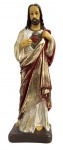 Imagem religiosa  Sagrado Coração de Jesus, Escultura religiosa em estuque francês  representando o Sagrado Coração de Jesus, com rica policromia em tons de vermelho, dourado e branco, vestes detalhadas e expressão serena. Base integrada. Peça devocional tradicional, ideal para oratórios ou decoração sacra. Apresenta desgastes naturais do tempo, compatíveis com a idade.Mede 31 cm.