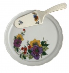 Prato para bolo com pá, em porcelana branca, decorado com motivos florais policromados. Prato de borda recortada e pá com decoração floral correspondente, formando conjunto harmonioso. Apresenta sinais leves de uso compatíveis com a antiguidade. Peça delicada, ideal para serviço, decoração ou composição de mesa clássica. Medida do maior 26 cm diâmetro.
