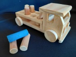 Brinquedo didático artesanal em madeira, no formato de caminhão. Possui 5 cilindros encaixáveis para trabalho de coordenação motora. Medidas: 10 cm de altura x 23 cm de comprimento.