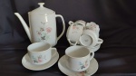 6 xicaras c/ pires acompanhadas de bule em porcelana branca, decoração floral em suaves tons. "Porcelana Pozzani"