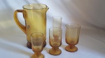 Jogo em Demi- Cristal translucido na cor ambar, composto por 1 Jarra - 10 Taças champagnhe/ 10 taças vinho tinto/ 10 taças vinho branço/ 10 taças de licor. Total 41 peças .