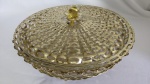 Bomboniere em metal dourado ricamente vazado c/ tampa. Acompanha travessa em vidro Marinex. Formato circular, pés elevados. Pega tampa em forma de flor. Alt.8cmx diam 28 cm. Bijoux Montmatre) sem uso na caixa.