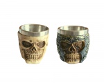 2 Copos de shot com tema de caveiras em resina e interior em inox. Material resistente com excelente acabamento, rico em detalhes, produzido de modo semi artesanal. Medidas: Altura: 6 cm. Diâmetro: 5,5 cm. Capacidade: 60 ml.