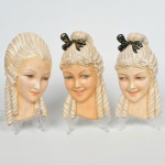 Conjunto de 3 Mascaras em faiança esmaltada, representando figuras Femininas, medindo a menor 26 cm e a maior 29 cm de altura.