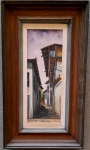 AFRÂNIO 1976 - Casario, óleo sobre madeira medindo 17x40 somente a obra e 35x58 com a moldura. Assinado e datado no canto inferior esquerdo. Cartão do artista fixado no verso.