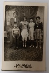 Antigo Postal Fotográfico  Retrato de Família  Estúdio Foto Bom Jesus (Interior SP)  Circa 1960Retrato de estúdio clássico apresentando uma família composta por casal e quatro filhos. A imagem destaca os costumes e a moda do interior paulista do meados do século XX, com fundo cenográfico de cortinas e piso decorado