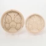CERÂMICA, dois (2) cinzeiros de tamanhos distintos, ornamentação relevada em elementos vegetalistas, esmaltação vítrea, marcados na base BY ELGA, medindo 15,5 cm e 18,5 cm diâmetro, sinais de uso, vide foto.