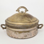 METAL PRATEADO, um (1) centro de mesa com tampa, borda em gradil, alças e pega da tampa relevadas em volutas, sem marca de manufatura aparente, medindo 26,5 cm diâmetro, sinais de uso, vide foto.