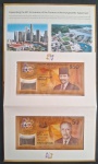 POLÍMERO - FOLDER COMEMORATIVO DOS 50 ANOS DE INTEGRAÇÃO DAS MOEDAS DE BRUNEI E SINGAPURA -RRRR