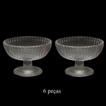 Conjunto de 6 manteigueiras de mesa em vidro translúcido. Formato ovalado com bordas onduladas e detalhes em relevo no corpo e na base. Design clássico, oferecendo um toque sofisticado à mesa posta. 7 x 10 cm.