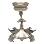 Centro de mesa em prata inglês Old Sheffield, repuxada e cinzelada, ornado em estilo Art Deco com esfinges e estilizações. Coluna central com adorno saliente a meia altura, encimado por pequeno bowl com bordas peroladas. Base cônica, com os animais de asas abertas e borda recortada com pés em degraus. Marcas do fabricante. 20 x 15 cm. Peso 770 gramas.