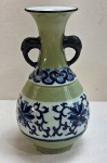 Vaso bojudo de porcelana oriental nas cores verde e branco, decorado com flores e guirlandas em azul cobalto em policromia. Alças com cabeças de réptil. Med. 25 x 14 cm.