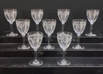 SAINT LOUIS-  Conjunto com nove  (09) taças para vinho do porto, haste longa, em fino cristal frânces  serviço "MANON"  translúcido, lapidação em guirlandas, florais e fitas. França. Século XX. 19 cm.  Med.12,5 x 9,5 cm diâmetro.