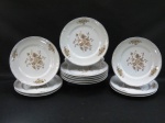 SCHMIDT - Doze (12) pratos rasos em porcelana moldada na pasta, decorada com florais, borda com frisos prateado. Med. 25 cm diâmetro.