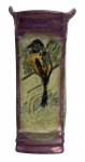 Vaso em faiança artística, estilo Art Nouveau, policromado, com painéis pintados à mão representando flores e pássaro, bordas em tom violáceo, assinatura e marca na base, apresentando marcas do tempo. Mede 17 cm altura.
