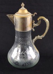 Jarra em cristal translúcido, lapidado com parreiras e uvas, guarnecido com borda e alça em metal espessurado a prata. Medindo: 29 cm.