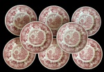 Barratts & Co., Staffordshire. Conjunto com oito pratos para sobremesa em faiança inglesa decoração em tonalidade vinho com cenas campestres e rica padronagem floral nas bordas, seguindo o tradicional estilo inglês transferware. Peças marcadas na base Barratts  Staffordshire  Made in England, apresentando craquelado natural do esmalteme. Mdidas: 20,5 cm de diâmetro