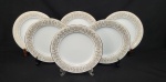 Noritake, Japan. Seis pratos rasos em porcelana japonesa esmaltada na cor branca, modelo Raphael, com rica decoração de flores, volutas e filetes em ouro. Manufatura no verso. Medindo: 27 cm.