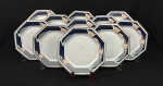 Schmidt, Brasil. Onze pratos rasos em porcelana esmaltada, em formato oitavado, decoração estilizada com policroma e frisos dourados. Sobre fundo branco. Manufatura no verso. Medindo:26 cm.