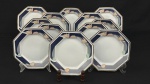 Schmidt, Brasil. Doze pratos para sobremesa em porcelana esmaltada, em formato oitavado, decoração estilizada com policroma e frisos dourados. Sobre fundo branco. Manufatura no verso. Medindo:19 cm.