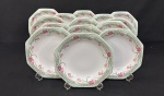 Schmidt, Brasil.  Quatorze pratos fundos em porcelana esmaltada, em formato oitavado, decorado com motivos florais em policromia. Manufatura no verso. Medindo:3 x 22 cm.