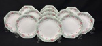 Schmidt, Brasil.  Doze pratos para sobremesa em porcelana esmaltada, em formato oitavado, decorado com motivos florais em policromia. Manufatura no verso. Medindo: 18 cm. 2 cm bicados.