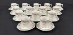 Schmidt, Brasil.  Quatorze xícaras para café em porcelana esmaltada, em formato oitavado, decorado com motivos florais em policromia. Manufatura no verso. Uma com bicado.