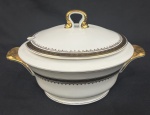 Mauá. Sopeira em porcelana esmaltada, decoração com friso preto e detalhes em dourado. Manufatura no verso. Med. 16 x 28 x 14 cm.