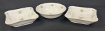 Três saladeiras em porcelana da República Tcheca, esmaltadas na cor branca, decoração floral policroma e filetes em ouro, bordas com ramos em relevo. Med. 6 x 22 x 22 cm e 7 x 25 cm.
