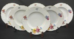 Hutschenreuther, Bavária, década de 1930. Seis pratos fundos em porcelana esmaltada, decoração floral policroma e frisos em ouro sobre fundo branco. Manufatura no verso. Medindo: 3 x 25 cm. 