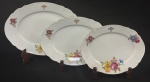 Hutschenreuther, Bavária, década de 1930. Três travessas ovais em porcelana esmaltada, decoração floral policroma e frisos em ouro sobre fundo branco. Manufatura no verso. Medindo:21 x 27 cm e 38 x 28 cm. 